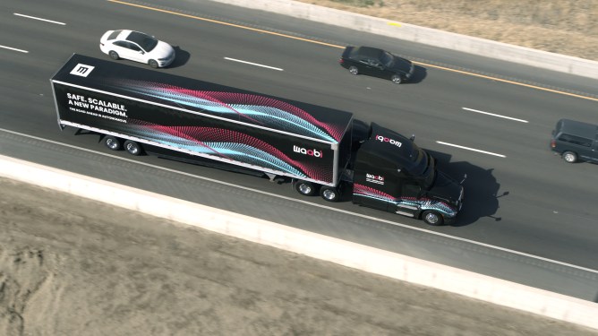Aerial photo of semi-truck by Waabi with words "Safe. Scalable. A new paradigm. The road ahead is autonomous."