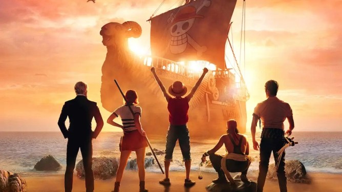 5 people looking out to sea at a pirate ship