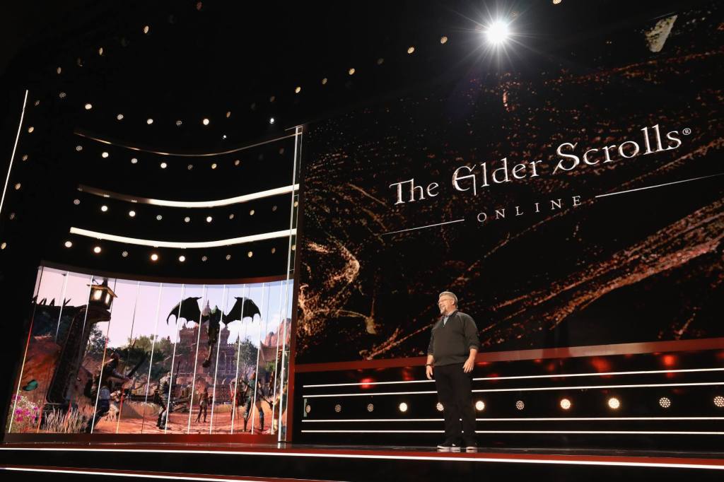 A man speaks on stage about Elder Scrolls, a game made by ZeniMax and a subsidiary of Microsoft
