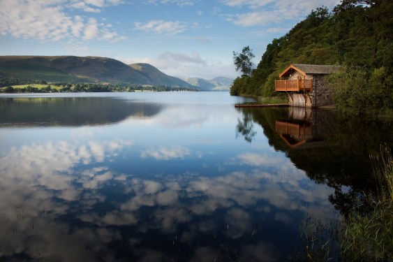 House overlooking lake and mountains.