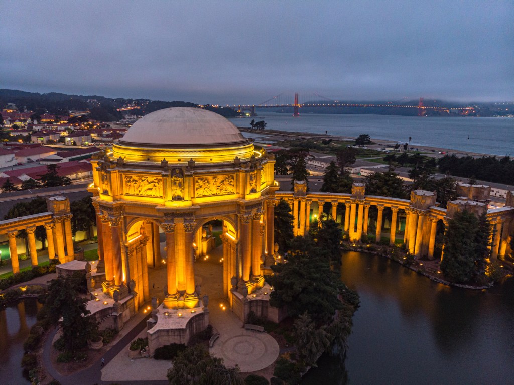 Palace of Fine Arts at night with reflection with the Golden Gate Bridge in the background, San Francisco, California, USA. (Dusk)