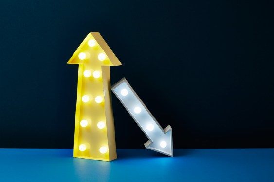 One big yellow arrow points up while a smaller white arrow leans on it and points down.