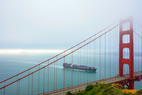 Cargo ship passing under the Goden Gate Bridge