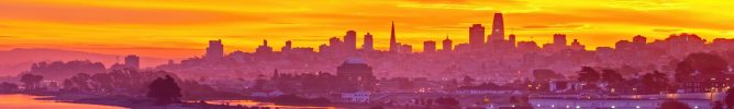 An aerial shot of a bright glowing sunset sky over San Francisco