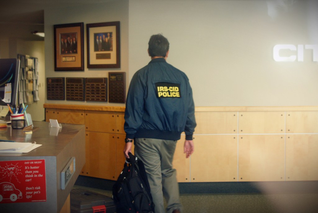 an IRS agent wearing an IRS-CID jacket