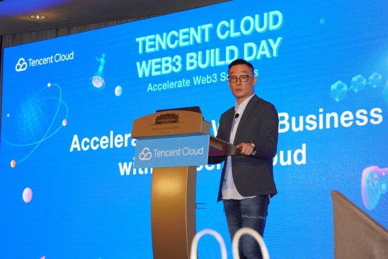 Poshu Yeung, Senior Vice President, Tencent Cloud International, standing at a podium onstage