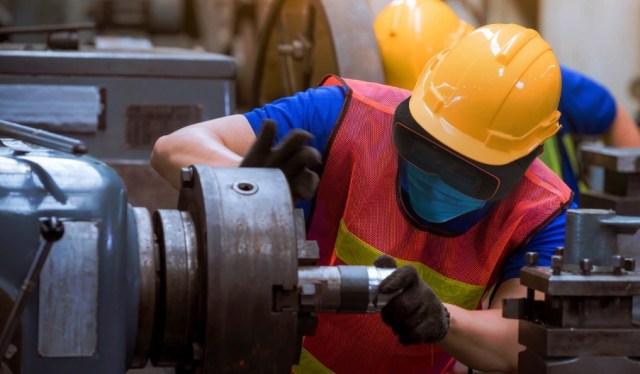 A worker looks at a machine wearing ThirdEye glasses