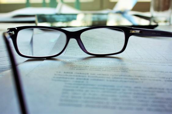 a pair of glasses on laptop displaying text