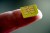close-up of a sim card on a finger