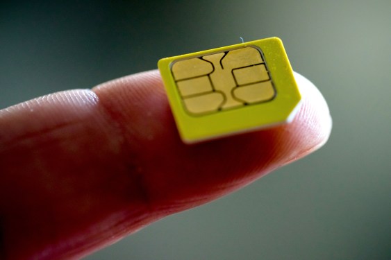 close-up of a sim card on a finger