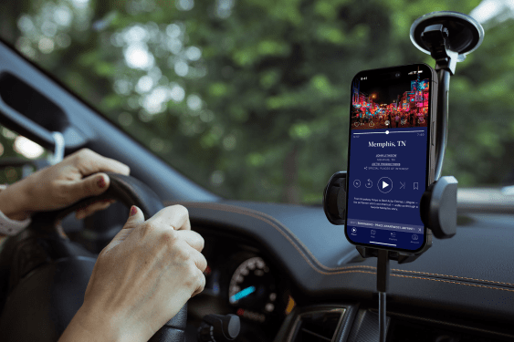 Autio app on a smartphone, displayed in a car.