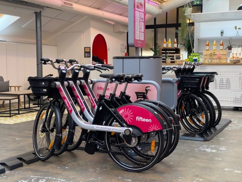 row of docked e-bikes