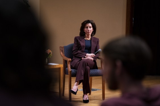 Gina Raimondo, seated
