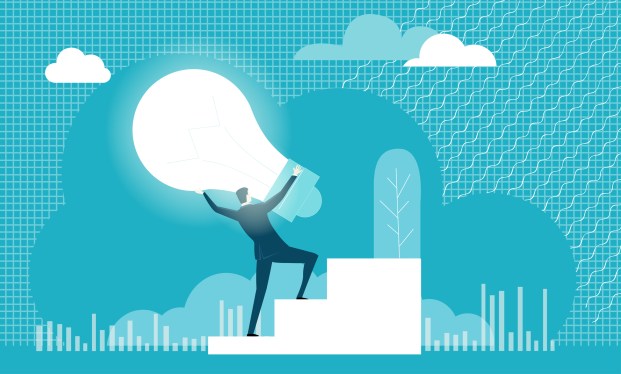 Business man carrying a light bulb representing an idea up a flight of stairs.