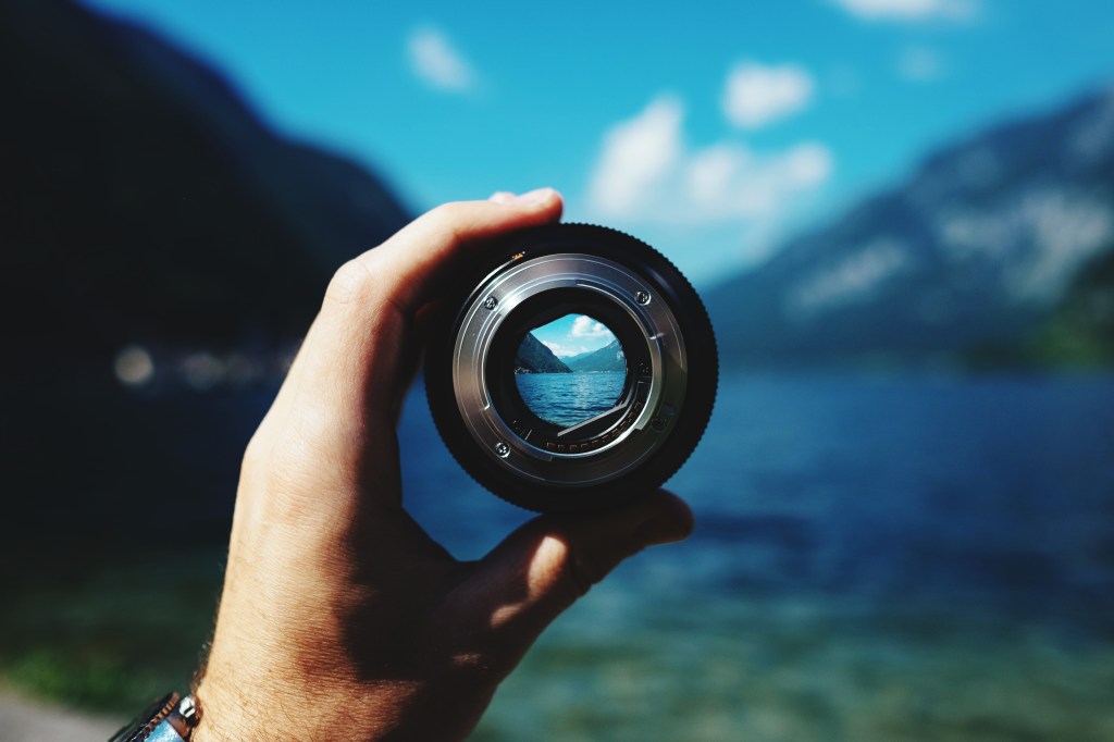 Closeup of a person holding a camera outside
