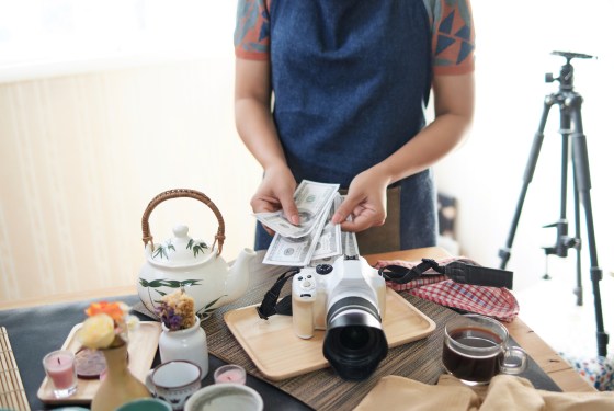 Stock photographer counting money after getting paid for session.