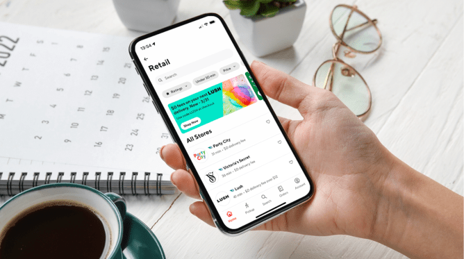 Hand holding mobile phone displaying DoorDash app