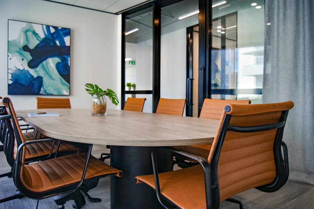 An empty board room with a round table and chairs