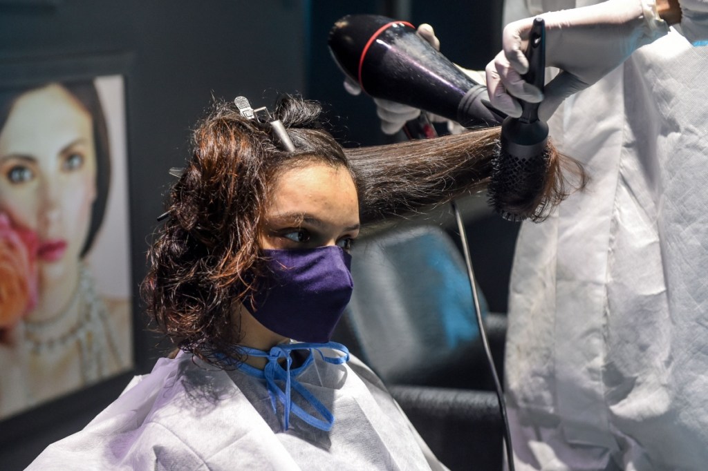 Indian salon, girl getting haircut/blowout.