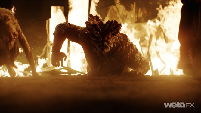 Scene from HBO's The Last of Us. A bloater coming out of a big ball of fire.