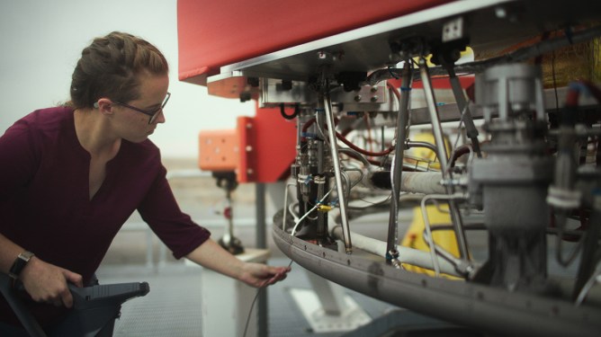 Stoke Space worker looking at launch hardware