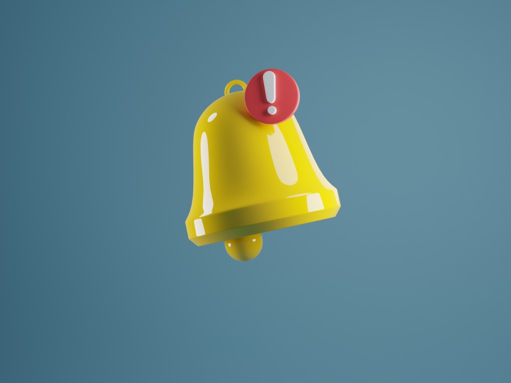 A yellow notification bell with a red exclamation point against a blue background.