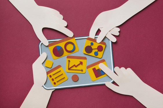 Paper craft illustration of digital tablet with charts. Teamwork concept