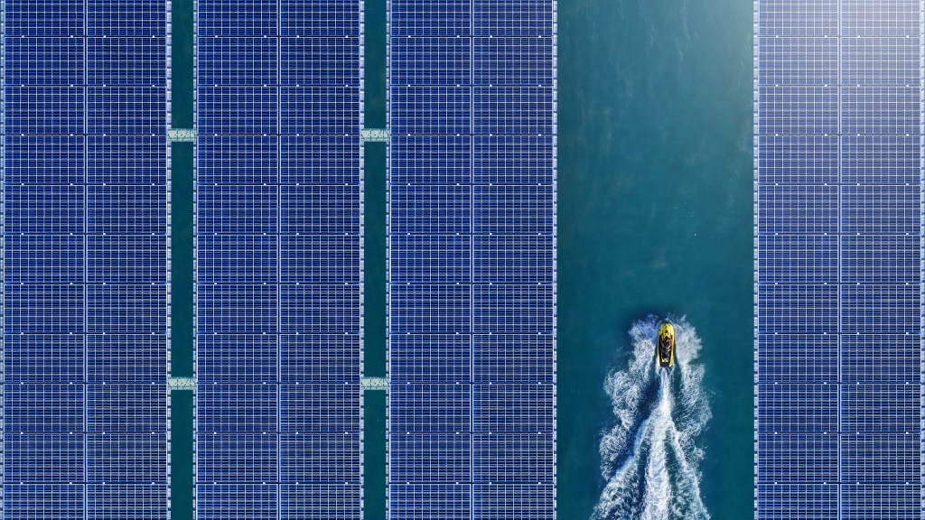 Jet ski moving through floating solar panels.