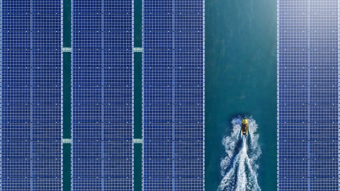 Jet ski moving through floating solar panels.