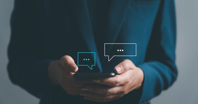 Women hand using smartphone typing Live chat chatting and social network concepts, chatting conversation working at home in chat box icons pop up. Social media marketing technology concept.