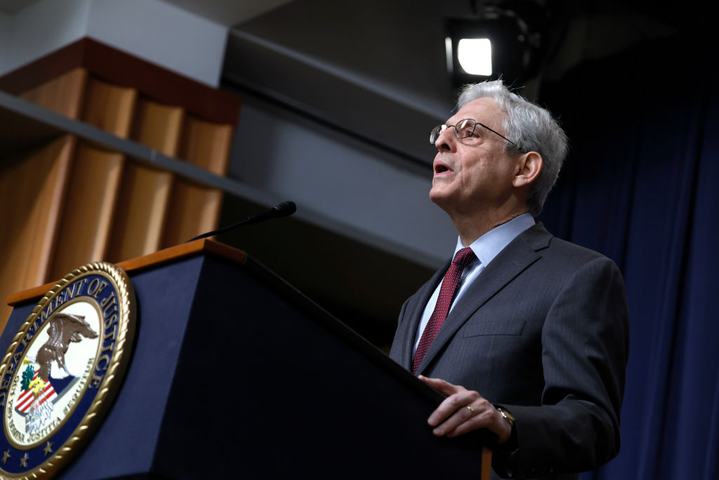 Attorney General Merrick Garland speaks at a podium with a DOJ symbol