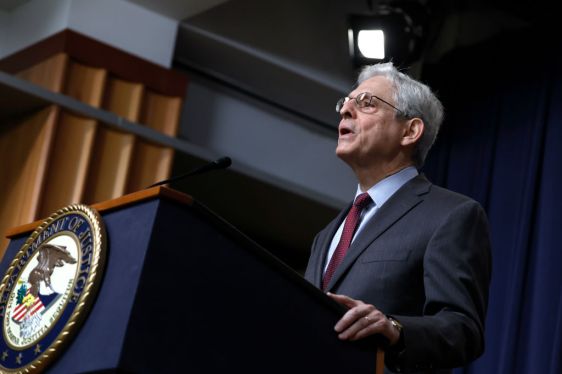 Attorney General Merrick Garland speaks at a podium with a DOJ symbol