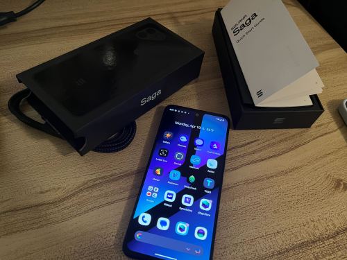 An image of the Solana Saga phone alongside a box and user guide