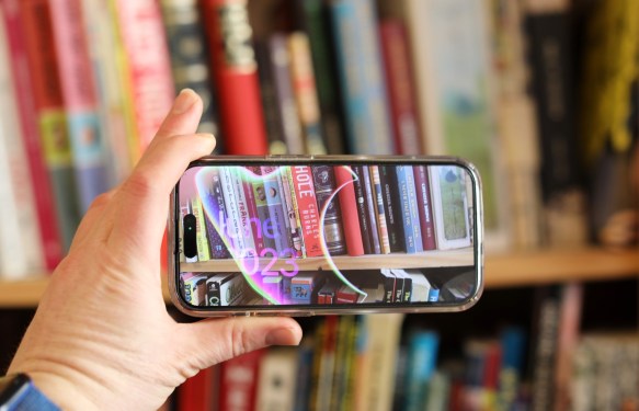Apple iOS smartphone camera pointed at books on a shelf
