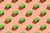 Green sponges on a pink background to symbolize green washing.