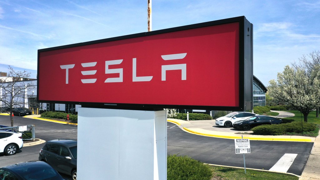 SCHAUMBURG, ILLINOIS - APRIL 19: A sign marks the location of a Tesla dealership on April 19, 2023 in Schaumburg, Illinois. Tesla announced price cuts for its Model 3 and Model Y electric vehicles in front of their 1st quarter earnings report due out today. (Photo by Scott Olson/Getty Images)