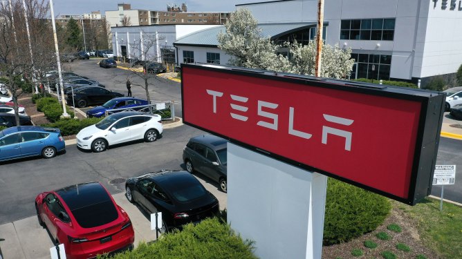 A sign marks the location of a Tesla dealership in Schaumburg, Illinois.