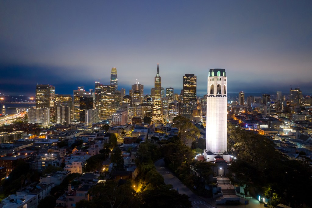 Colorful epic aerial panorama of San Francisco skyline downtown with business building skyscraper and waterfront at twilight in California, USA.