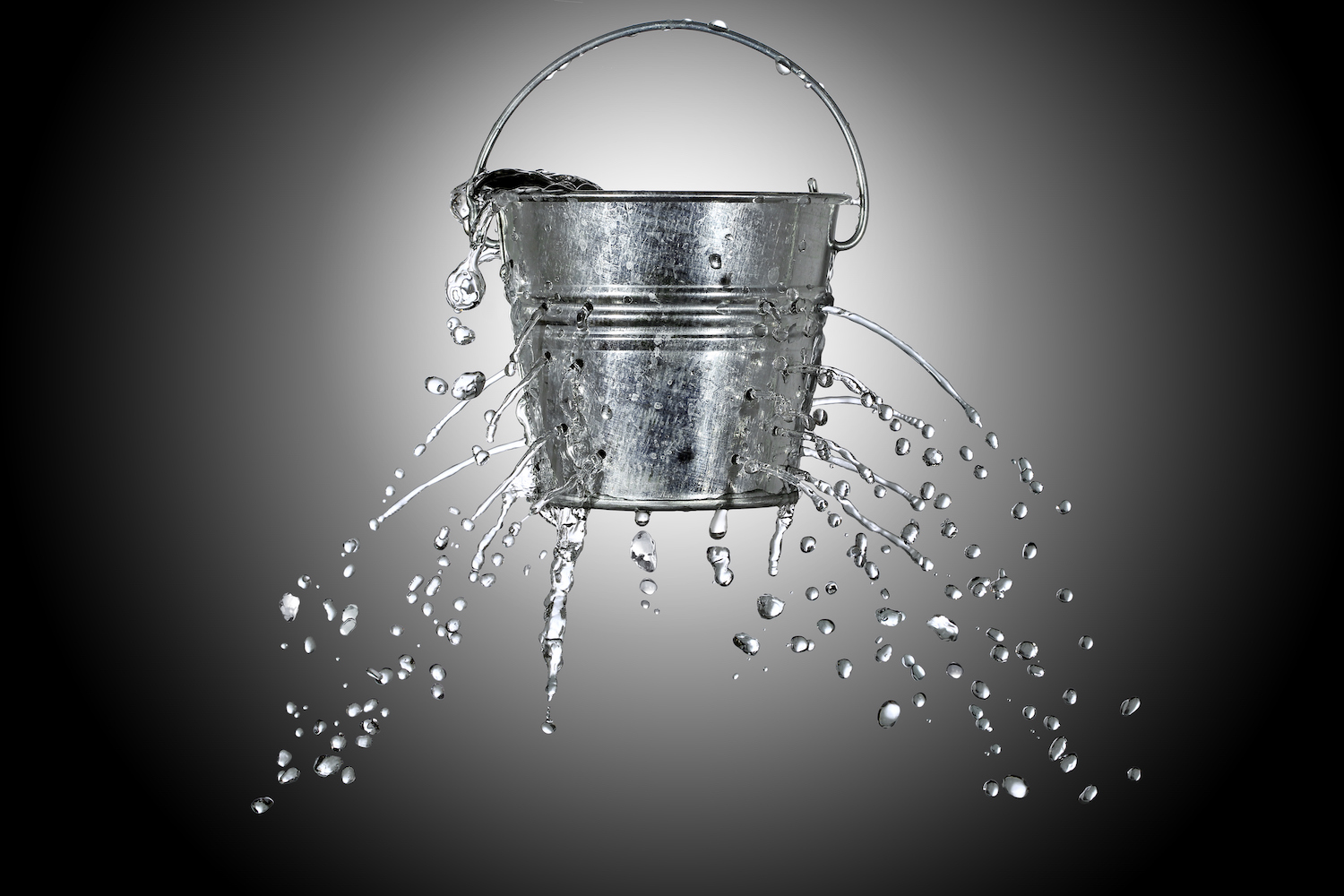 water is coming out of a bucket with holes