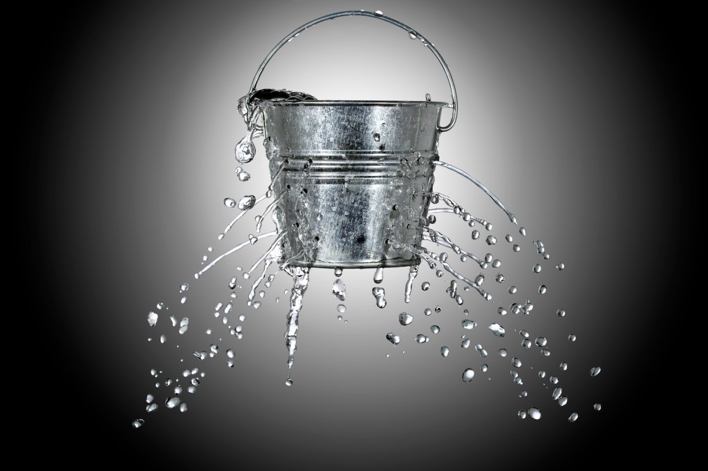 water is coming out of a bucket with holes