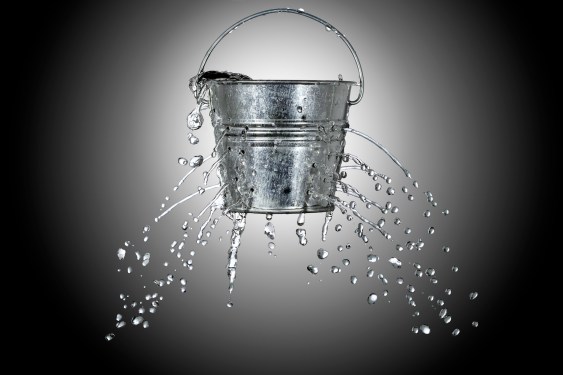 water is coming out of a bucket with holes