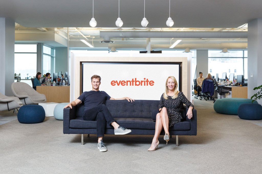 Eventbrite founders Julia and Kevin Hartz seated on a couch