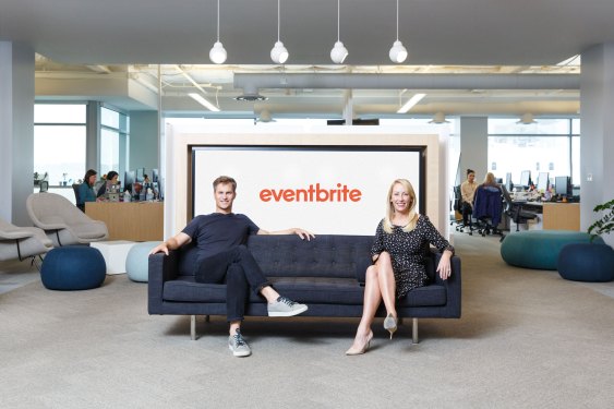 Eventbrite founders Julia and Kevin Hartz seated on a couch