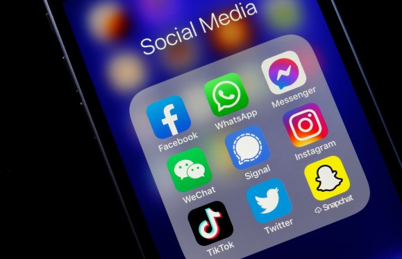 An iphone showing the most popular social apps in a folder.