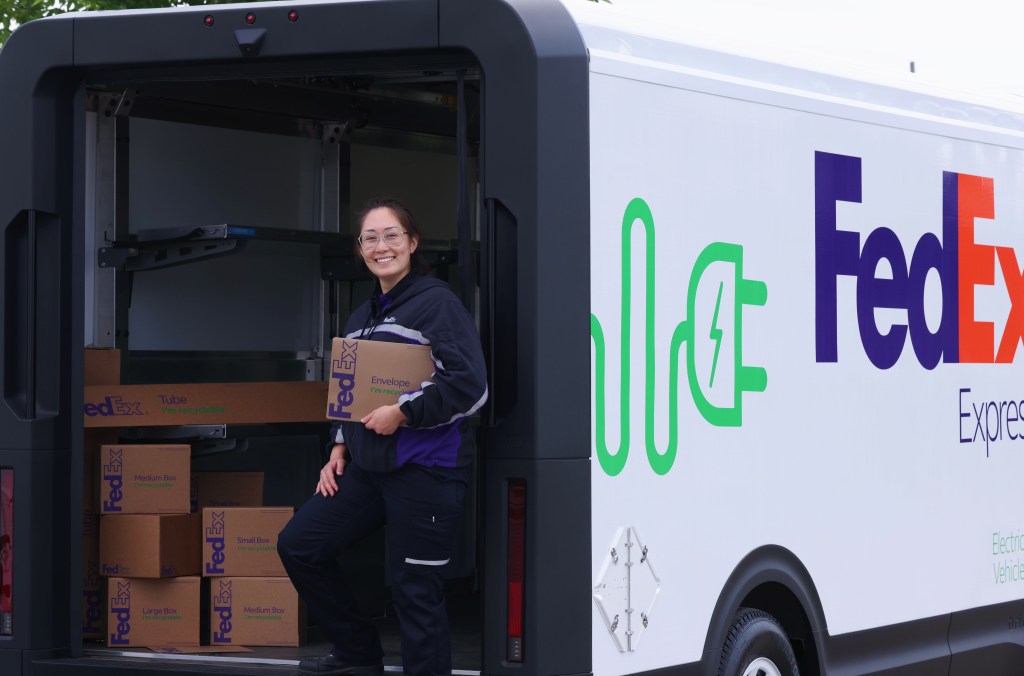 Employee in FedEx truck with packages