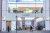 People walk past a Microsoft store entrance with the company's logo on top in midtown Manhattan