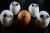 Brown face represented with an egg surrounded of white persons / eggs. Racism concept