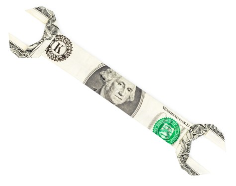 Dollar origami spanner wrench isolated on white background. Moneygami.