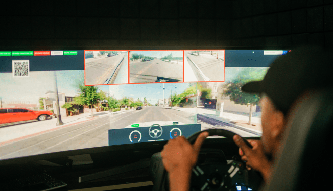 Halo Car remote driver in front of screen with street data