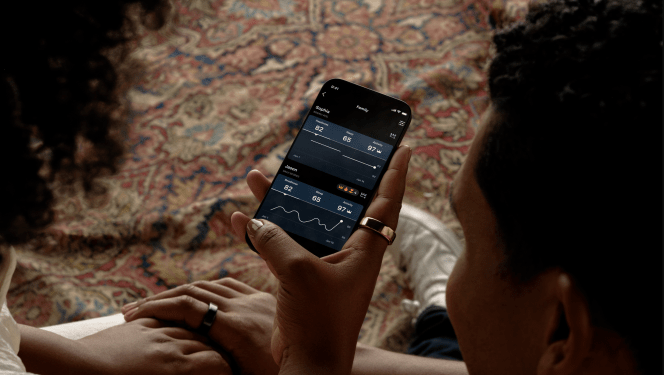 people looking at Oura Circles app on smartphone